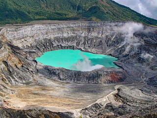 top view to the bright turquoise crater lake of the poas volcano with fumaroles in costa rica © mschauer