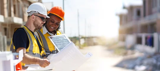 Poster Professional - senior civil engineers inspecting or working in construction site, contractor examining a building blueprint or layout on paper. © DG PhotoStock