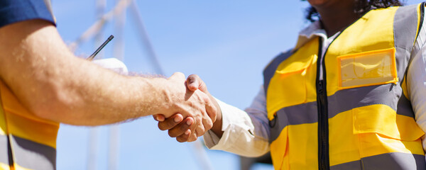 Construction foreman and client making a handshake together after completed the new contract.