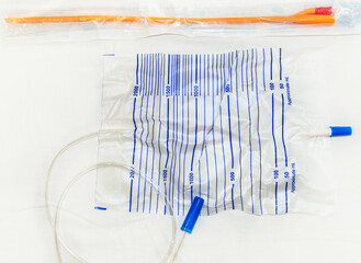 Urinary catheter and 2 liter sterile drainage bag is isolated on a white background.