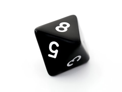 A black D8 eight sided dice isolated on white. RPG dice. Octahedron DND dice