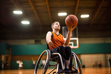 A disabled man in a wheelchair throws a basketball into a basket. Sports for people with disabilities. Active lifestyle. - obrazy, fototapety, plakaty