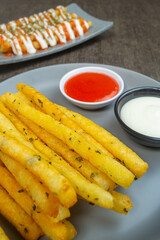 stik kentang keju or fried cheese potato sticks served with chili sauce and mayonnaise sauce