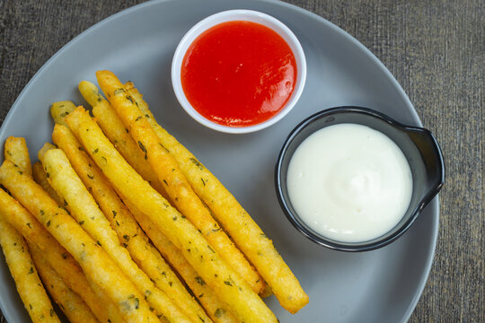 stik kentang keju or fried cheese potato sticks served with chili sauce and mayonnaise sauce.top view food
