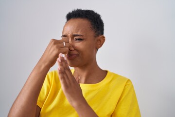 African american woman dong bad smell gesture over isolated white background