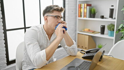 Handsome young caucasian man, a serious business worker, engrossed in his thoughts at office,...