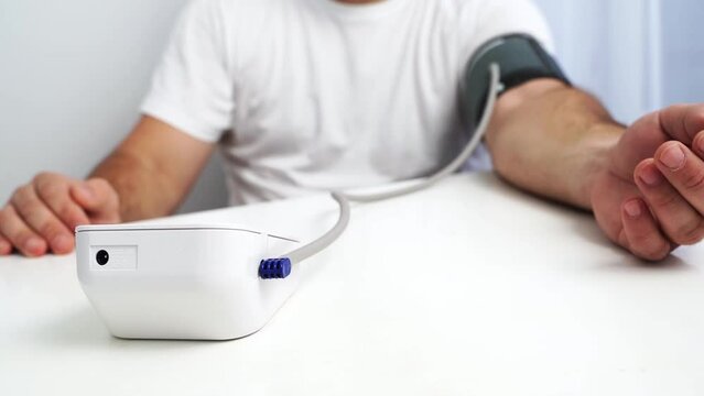 the girl measures blood pressure with a tonometer