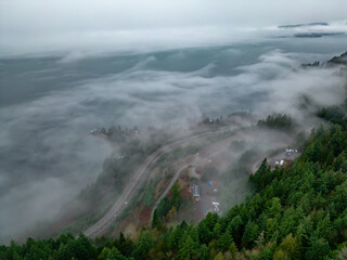 Howe Sound covered in Clouds and Fog during morning. Aerial Panorama