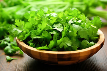 coriander chopped on wooden bowl