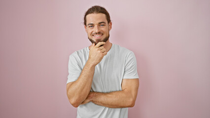 Young hispanic man smiling confident standing over isolated pink background