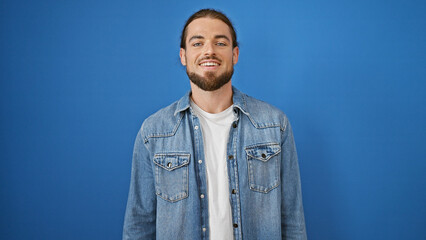 Young hispanic man smiling confident standing over isolated blue background