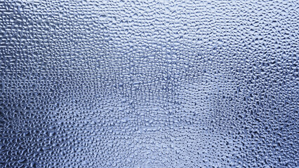 Condensation on window glass in frosty winter weather. Background in the form of small drops on the glass