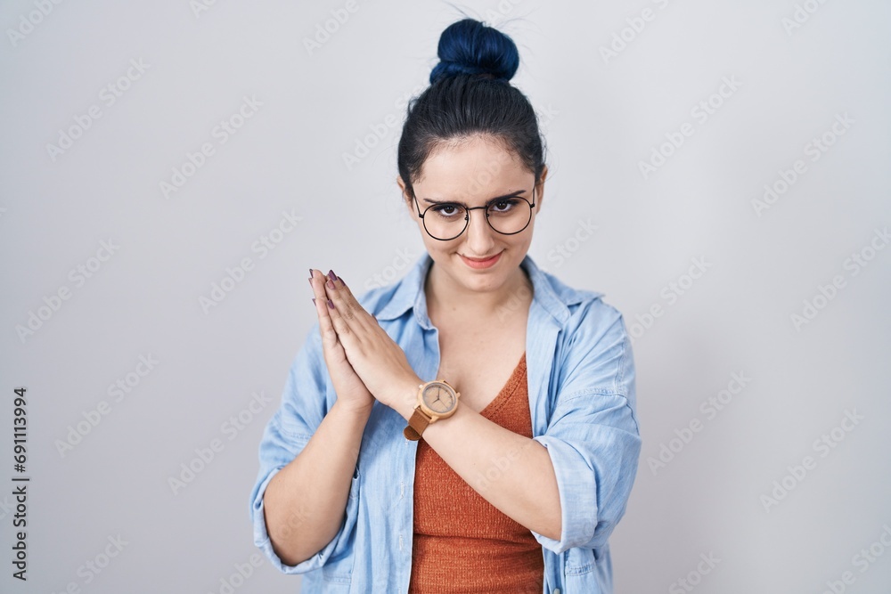 Sticker Young modern girl with blue hair standing over white background clapping and applauding happy and joyful, smiling proud hands together