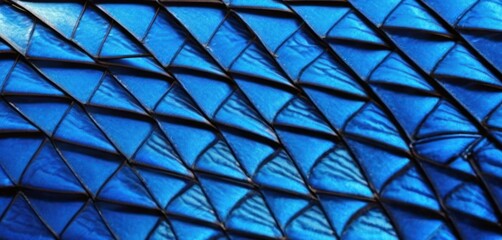  a close up view of a blue pattern on a piece of material that looks like a snake's tail. - obrazy, fototapety, plakaty