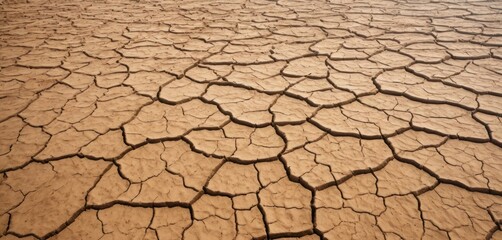  a large area of dry land that is brown with cracks in the middle of it and a sky in the background.