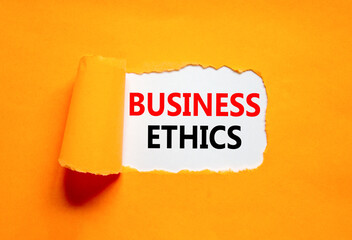 Business ethics symbol. Concept words Business ethics on beautiful white paper. Beautiful orange paper background. Business ethics concept. Copy space.