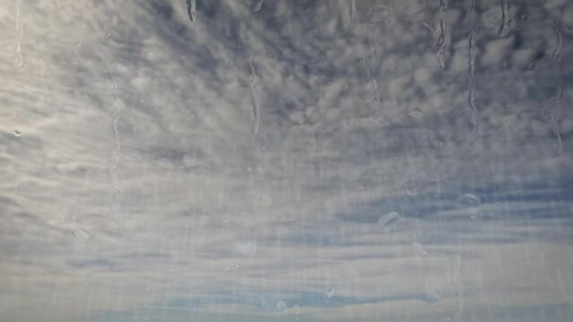 sky timelapse of rain on pretty blue sky with little clouds - loop video