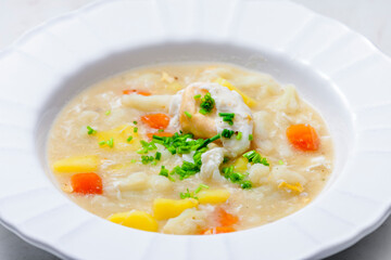 cauliflower soup with carrot, potatoes and poache egg