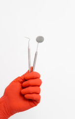 Teeth healthcare equipment holding. Dentistry tools in gloved hands.