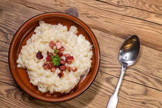 Slovakian halusky served with sheep cheese and roasted bacon