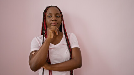 Beautiful african american adult woman rocks braids, pondering with doubt, a pipe dream over her...