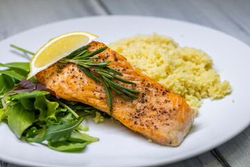 grilled salmon served with couscous and vegetables salad