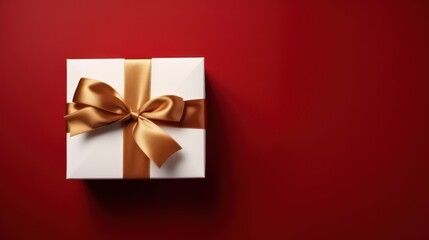 an open gift with gold ribbon and bow on red background