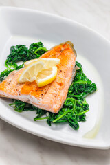grilled salmon fillet with spinach leaves salad