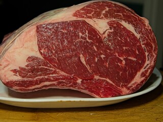 Beef prime rib roast in stages of preparation