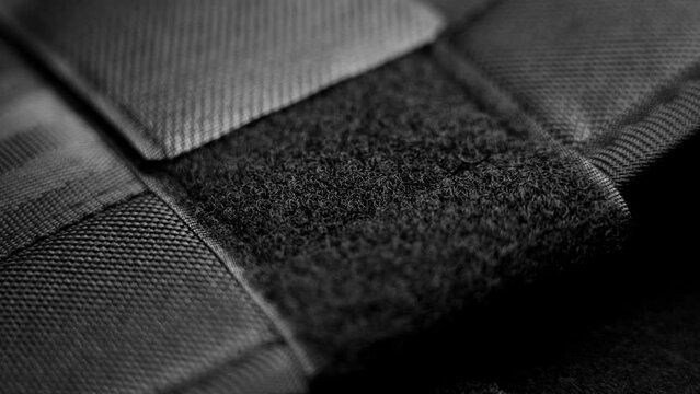 Nylon velcro fastener strip in black color. Macro shot. Rotation