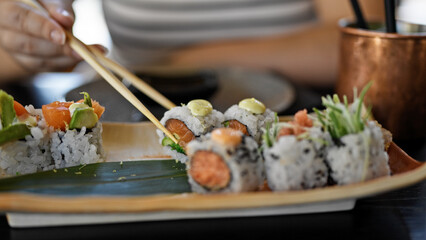 Eating sushi with chopsticks