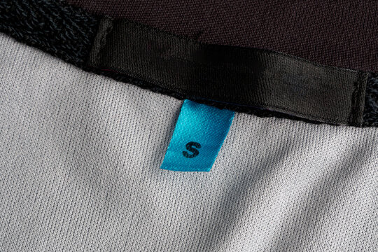 The emblem is missing from the clothing, an empty tag for the logo, copy space