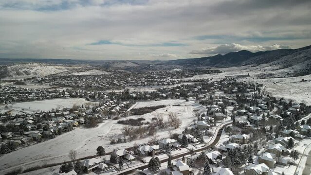 Aerial above Ken Caryl Ranch neighborhood in Littleton Colorado in winter covered in snowy