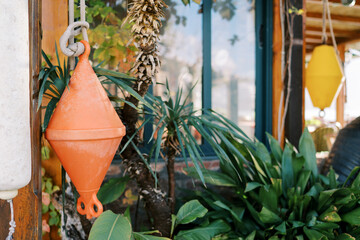Double anchor buoys hanging from ropes on the terrace of the restaurant