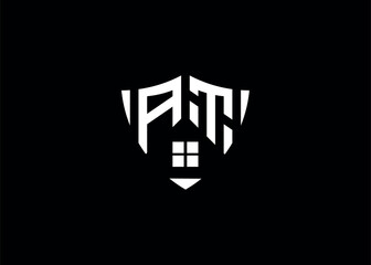 Real estate letter AT shield shape logo and house building vector template