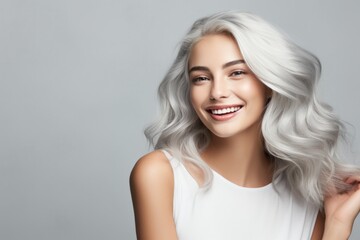 young woman with white hair and silvery grey hair smiling
