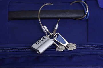 Blue Travel bag with a padlock and steel wire protecting against thieves when traveling