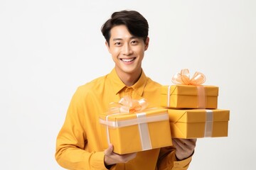 Cheerful young Asian man holding many present boxes with on white background. Black friday sale and Boxing day. Gift for woman and Valentine day. Christmas and Chinese New Year concept