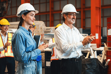 Happiness and joyful atmosphere, smiling factory worker and engineer celebrate with factory...