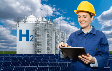 Female engineer with tablet computer on a background of Hydrogen factory