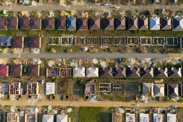 Construction of a suburban neighborhood of cottages. Aerial view.