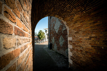 View through the gate and passage in the medieval city wall from the Zuidhavenpoort to the city...