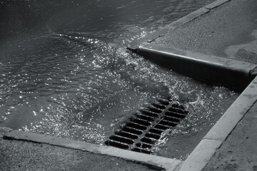 Flow of water during heavy rain and clogging of street sewage. The flow of water during a strong...