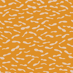Yellow pattern of hand drawn peanut shapes inspired in African safari prints. Vector seamless pattern design for textile, fashion, paper, packaging and branding