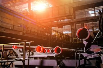 Freshly cast red hot iron pipe at the foundry - obrazy, fototapety, plakaty