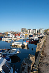 Fototapeta na wymiar Photo of fishing boats moored in West Bay harbour in Dorset