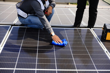 Fototapeta premium Solar technician cleaning the solar panel , Green and renewable energy concept