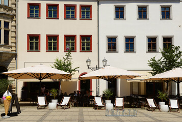 View of street cafe with tables and chairs