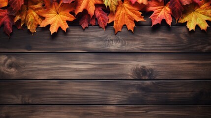The view from above of autumn leaves with a wooden background.