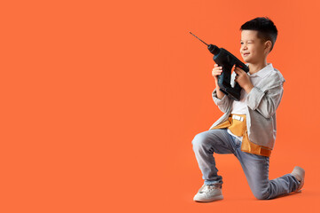 Cute little worker with drill on orange background - obrazy, fototapety, plakaty